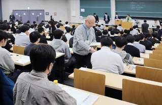 問題用紙の配布を待つ受験生ら＝１７日午前、神戸市東灘区岡本８、甲南大