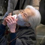 姉を亡くした井口千恵さん。銘板の名前を見て涙を流した＝１７日午前６時５６分、神戸市中央区加納町６、東遊園地（撮影・大田将之）