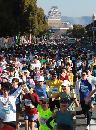 姫路城を背に一斉にスタートするランナー＝２２日午前、姫路市の大手前通り（撮影・辰巳直之）