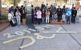 東日本大震災の被災地に思いをはせ、犠牲者に黙とうをささげる人たち＝１１日午後２時４６分、神戸市中央区加納町６、東遊園地（撮影・吉田敦史）