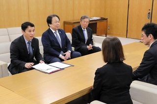 県立大無償化の事業評価に関して県幹部に申し入れる自民県議団の谷口俊介幹事長（左端）ら＝県庁