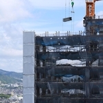 街並みにそびえ立つように建設中の神戸三宮ツインゲート１期ビル＝神戸市中央区雲井通７から