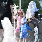 暑さを和らげるため噴水の周りで遊ぶ子どもら＝２２日午後、神戸市中央区波止場町（撮影・風斗雅博）