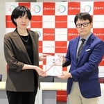 日本ＩＤＤＭネットワークの内野麻里子事業部長（左）から目録を受け取る神戸大の浅利貞毅特命教授＝神戸市中央区楠町７