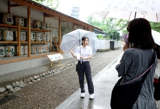 西宮神社と日本酒のつながりを説明するガイド役の田中怜歩さん＝西宮市社家町、西宮神社