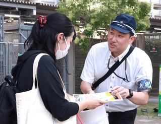 情報提供を呼びかけるビラを配る捜査員ら＝31日午後、神戸市灘区灘北通５