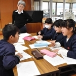 せりふを考える子どもたちの様子を見る平田オリザさん＝豊岡市土渕、中筋小学校