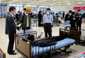 展示された福祉用具について説明を受ける来場者＝神戸市中央区浜辺通５