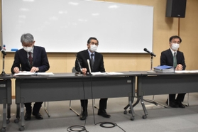 伊丹市立緑丘小学校に勤務する教員の感染が判明し、会見する木下誠教育長（中央）ら＝伊丹市千僧１