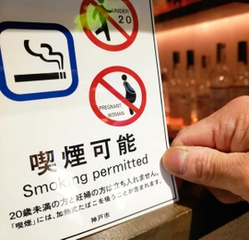 店内で喫煙できることを示すステッカー。「未成年と妊婦は立ち入れない」と案内する＝神戸市中央区
