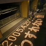 ろうそくの明かりで浮かび上がった「２００５・４・２５　わすれない」の文字＝２４日夜、尼崎市久々知３（代表撮影）