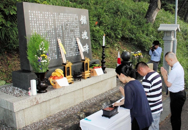 慰霊碑の前で香住沖海戦戦没者の冥福を祈る慰霊祭の参列者＝２０１９年８月３日、兵庫県香美町香住区一日市