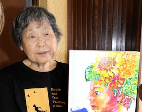 ３０年の記念誌を手に、活動を振り返る高橋智子元教諭＝神戸市西区