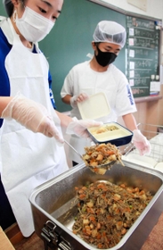 食缶に入れられ、熱々の状態で届いた「牛肉とじゃがいものみそ煮」を盛り付ける生徒＝７月１７日、神戸市垂水区神陵台３、神陵台中学校