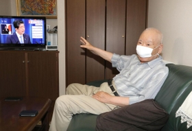 安倍首相の辞任表明を受け、取材に応じる有本明弘さん＝２８日午後、神戸市長田区（撮影・辰巳直之）