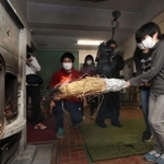 自分たちでおこした火をストーブに移す児童ら＝２３日午前、神戸市立六甲山小学校