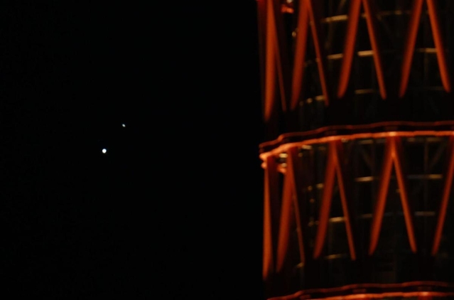 神戸ポートタワー越しに大接近した木星（左下）と土星＝２１日午後６時１６分、神戸市中央区から（撮影・吉田敦史）