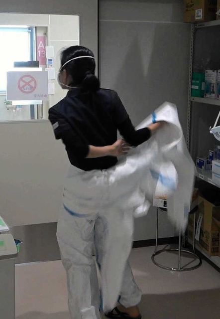 気管挿管が難航し、急きょ防護服を着て病室に支援に向かう医師＝２５日午後、神戸市中央区港島南町２、同市立医療センター中央市民病院