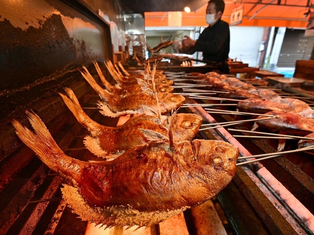 焼き上げられていく「にらみ鯛」。香ばしいにおいが店中に満ちた＝２７日午前、明石市本町１
