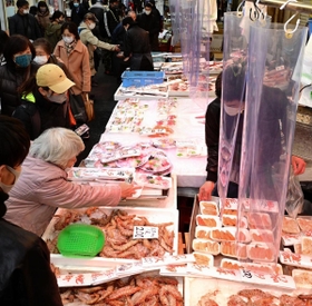 新年の装いが施された東山商店街で有頭エビなどを買い求める人々。まだ人出は少なめで、にらみ鯛などが並ぶ２９日以降になるとにぎわいが本格化するという＝２７日午後、神戸市兵庫区の東山市場（撮影・中西幸大）