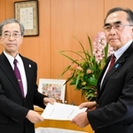 自民党兵庫県議団の藤本百男幹事長（右）から立候補の要請書を受け取る金沢和夫副知事＝２５日午後、兵庫県庁