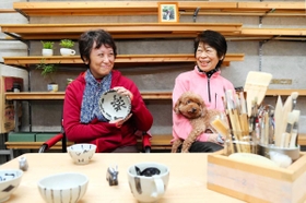 「楽」の字をデザインした大皿を持つ鈴木順子さん（左）と母もも子さん＝西宮市内（撮影・大山伸一郎）