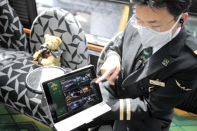 共有スペースの混雑状況を知らせるタブレット。奥は展望車で席の間隔を空けるために置かれたテディベア