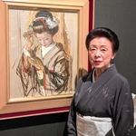 モデルを務めた小磯良平の名画「化粧する舞妓」の前に立つ芸妓・久富美さん＝神戸市立小磯記念美術館
