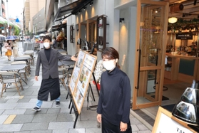 ようやく本格的にオープンし、小雨の中で営業する飲食店の店員たち＝１２日午後、神戸市中央区加納町４（撮影・吉田敦史）