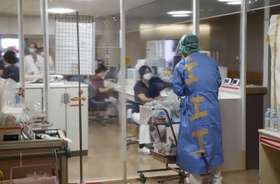 厳重に区域分けされたコロナ病棟のレッドゾーン（感染区域）で作業する職員＝１２日午前１１時４０分、神戸市長田区一番町２、市立医療センター西市民病院