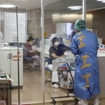 厳重に区域分けされたコロナ病棟のレッドゾーン（感染区域）で作業する職員＝１２日午前１１時４０分、神戸市長田区一番町２、市立医療センター西市民病院