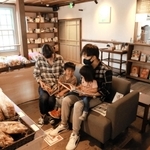 妖怪の本を読んでくつろぐ家族連れ＝福崎町西田原