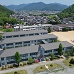 モダンな外観が山あいに映える西脇小学校の木造校舎３棟（小型無人機で撮影）＝西脇市西脇（撮影・大森　武）