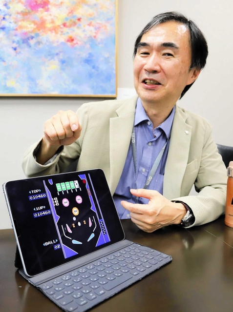 自身がプログラミングした「ピンボール」の画面を見せながら当時を振り返る松岡さん＝神戸市中央区港島南町７、理化学研究所計算科学研究センター