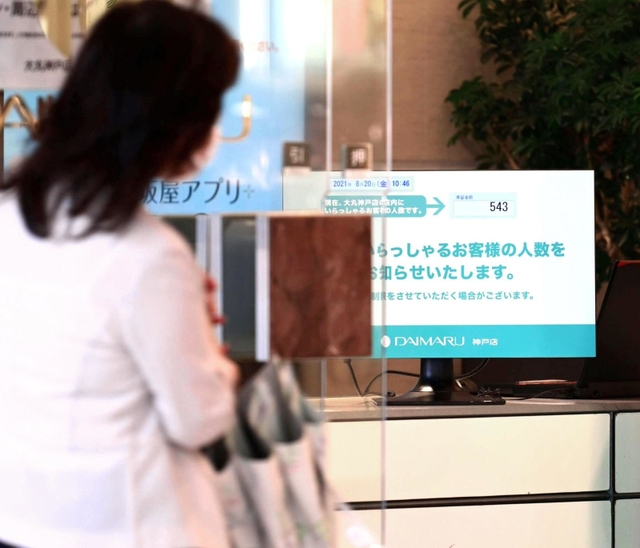 緊急事態宣言発令に合わせ、大丸神戸店の出入り口には店内の入場者数を示したパネルが設置された＝２０日午前、神戸市中央区明石町（撮影・坂井萌香）