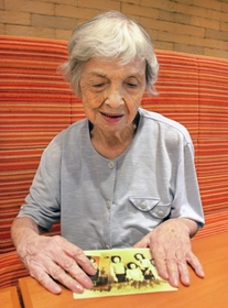 昔の写真を見ながら戦時中の思い出を語る吉田敦子さん＝神戸市内