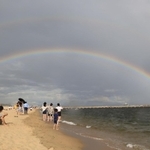 突然の雨とともに砂浜の向こうに架かった巨大な二重の虹＝６日午後、神戸市須磨区須磨浦通４（撮影・小林良多）