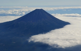 定期便より高度を低くして飛行する遊覧フライト。迫力のある富士山が見えた＝静岡・山梨県境上空から