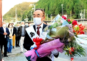 ５選を決めて花束を受け取り、笑顔を見せる庵逧典章氏＝佐用町佐用（撮影・大山伸一郎）