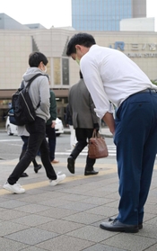 衆院選投開票から一夜明け、街頭で通行人に頭を下げる当選者＝１日午前、神戸市中央区（撮影・秋山亮太）