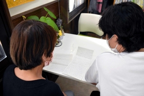 万引常習者の女性（左）が服役中に、次男（右）へ送った手紙には繰り返し反省の言葉がつづられていた＝神戸市内