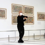 富塚純光さんの作品の前で踊る岩下さん＝神戸市東灘区岡本８、甲南大学岡本キャンパス