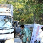養鶏場から出る自衛隊車両を消毒する県職員＝１７日午前、姫路市内（撮影・大山伸一郎）
