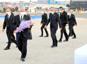 明石砂浜陥没事故２０年となり、花束を手に現場を訪れた明石市の泉房穂市長（左から２人目）と市幹部ら＝３０日午前、明石市大蔵海岸