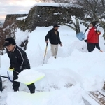 朝来市職員やボランティアガイドら約２５人が参加して雪かきをした＝２０２１年１２月２８日夕、竹田城跡