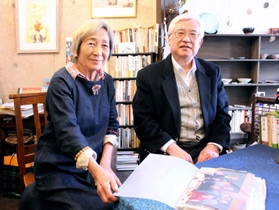 濱口竜介監督と撮った写真を前に談笑する詩人の福永祥子さん（左）と正岡健二さん＝神戸市須磨区