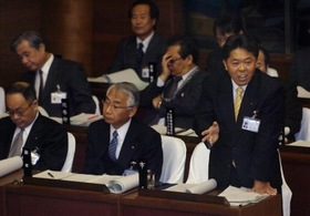 市議会で厳しい質問に対し答弁する北口寛人市長（右）＝２０１０年１２月７日、明石市役所