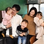 竹野海岸の近くでゲストハウスをオープンした権赫讃さん（左から２人目）と家族＝豊岡市竹野町竹野