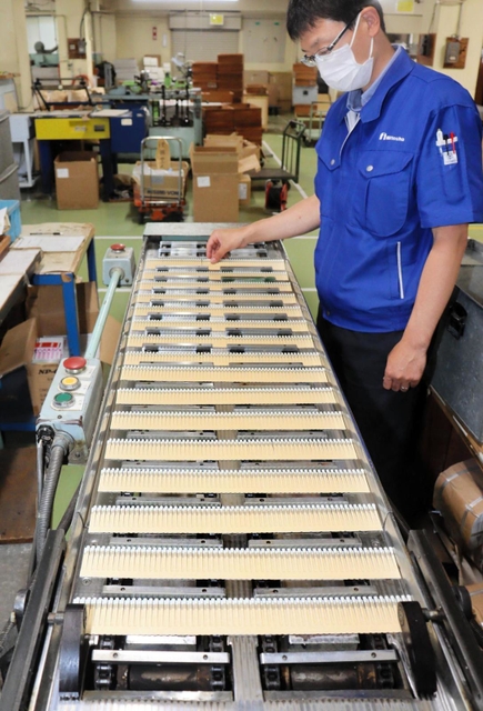 ブックマッチを製造する機械。１時間に約１万個が作られる＝姫路市東山、日東社