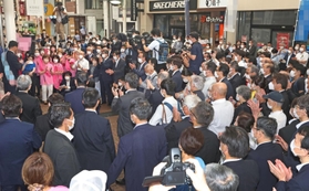 第一声を発し、集まった支援者から拍手を受ける候補者＝２２日午前、神戸市中央区（撮影・長嶺麻子、画像の一部を加工しています）